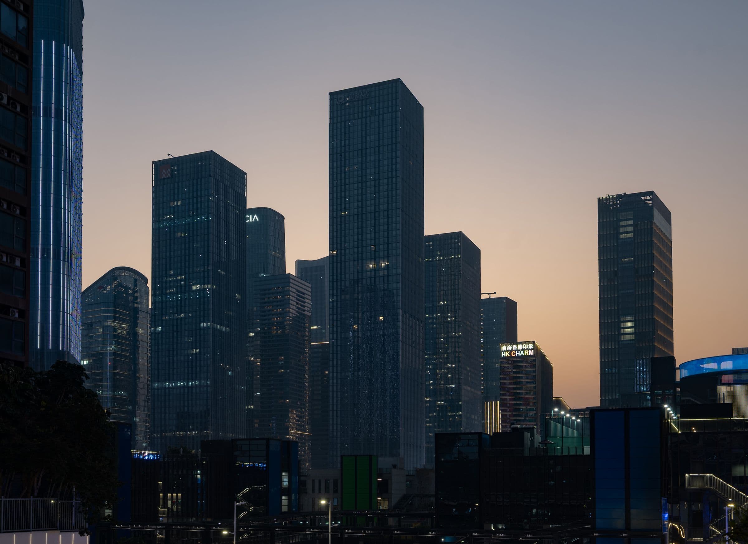 City skyline of modern towers at twilight — flagship construction and real estate work by Reliable ArCon in Pakistan